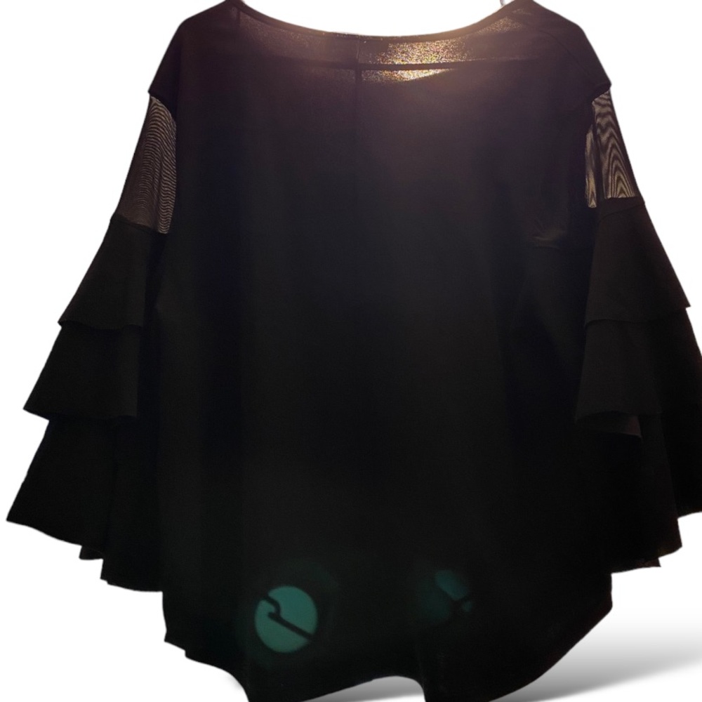 Black shirt with beautiful black ruffles on the arms of the shirt